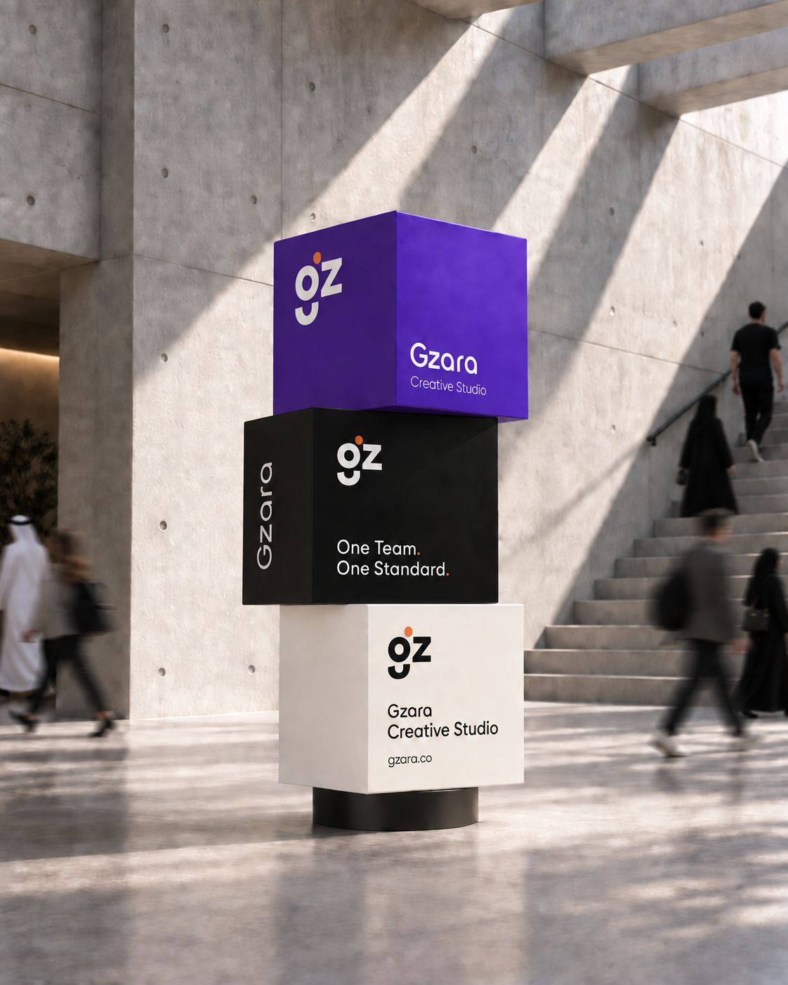 Gzara Creative Studio branded totem signage in a concrete lobby